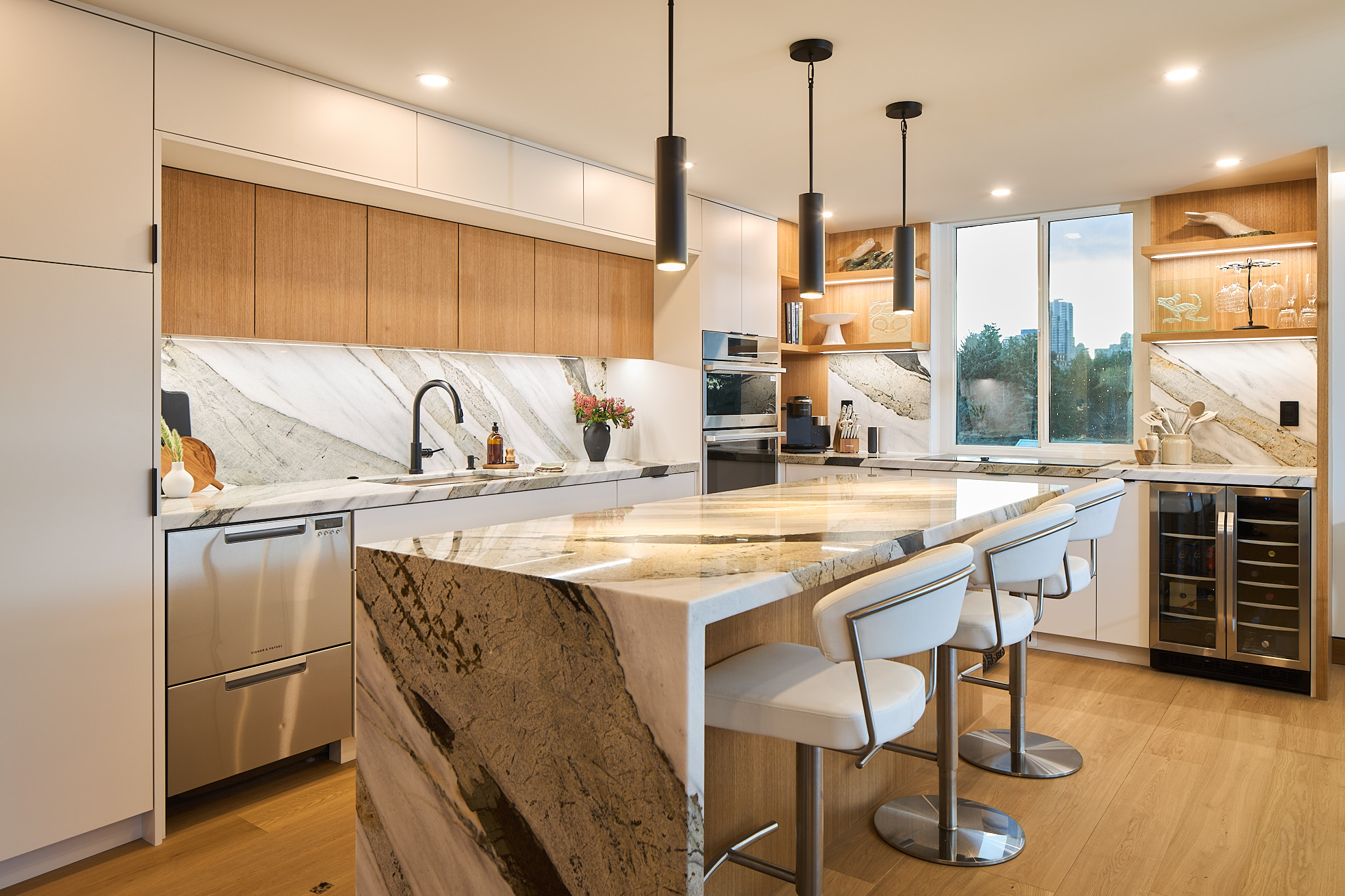Custom kitchen with Merit Kitchens cabinets and a marble island